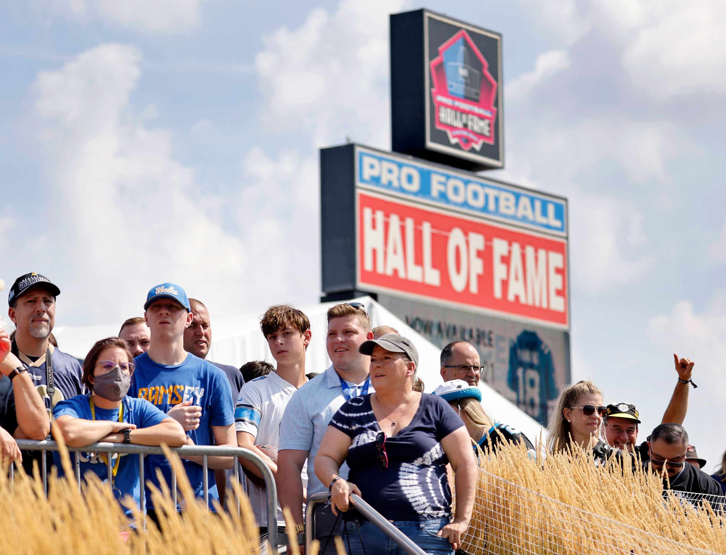 Football fans wait for the front door to open at the Pro Football Hall of Fame in Canton,...