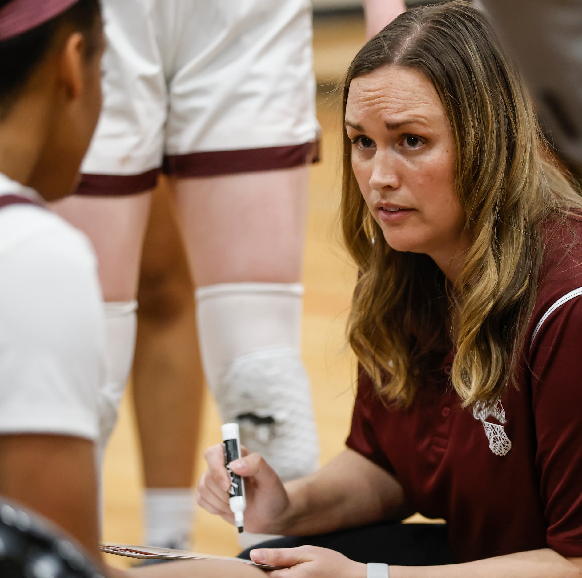 Plano Senior High School head coach Kelly Stallings draws a play on a white board while...