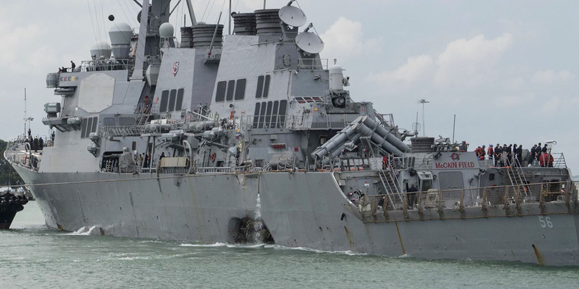 The guided-missile destroyer USS John S. McCain steers towards the Changi Naval Base in...