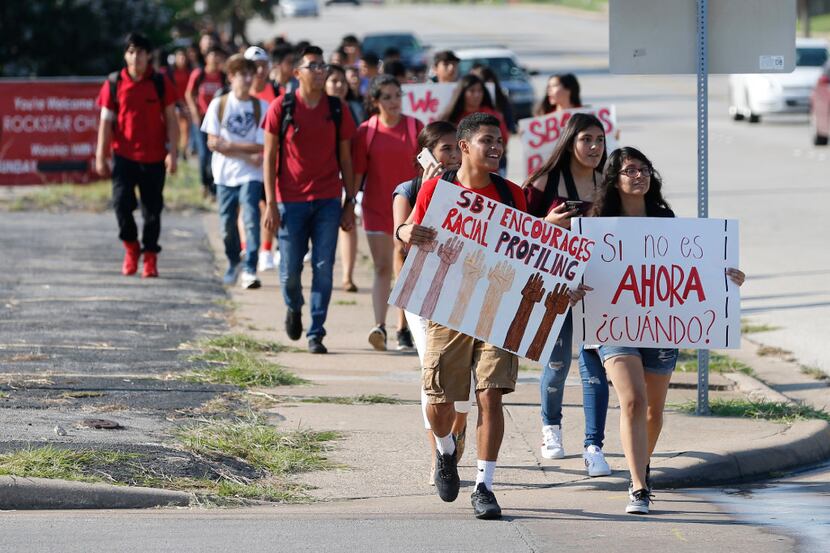 South Hills High School students marched toward Little People Park to rally together in...