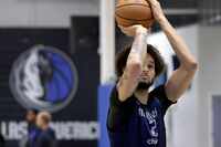 Dallas Mavericks center Dereck Lively II shoots free throws during practice at their...