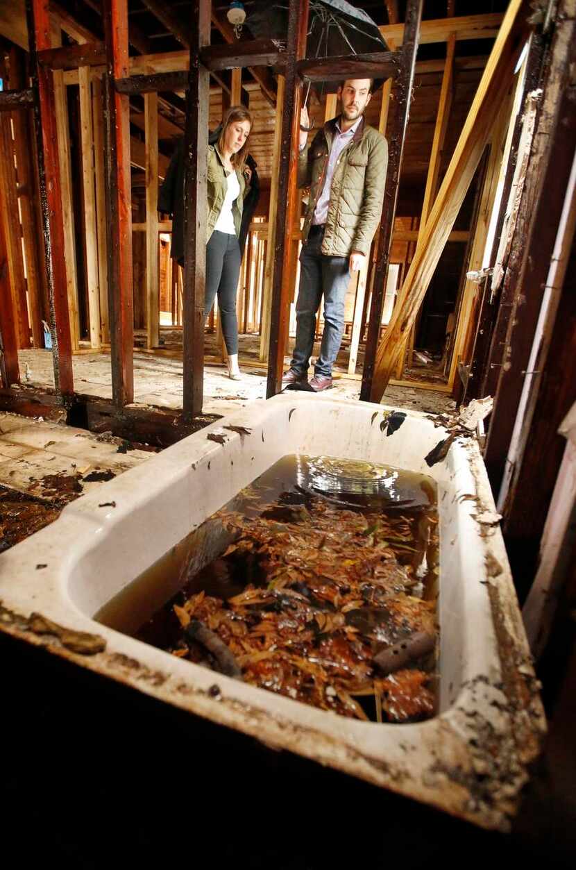Rain water filled  an old bathtub in the Lairs’ historic home Friday. Repeated delays in...