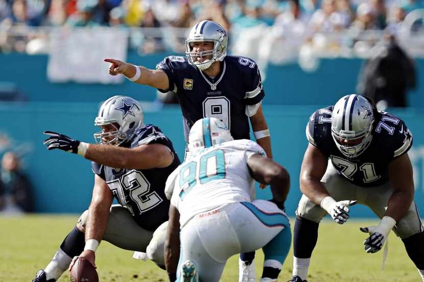 Dallas Cowboys quarterback Tony Romo (9) and center Travis Frederick (72) at the line during...