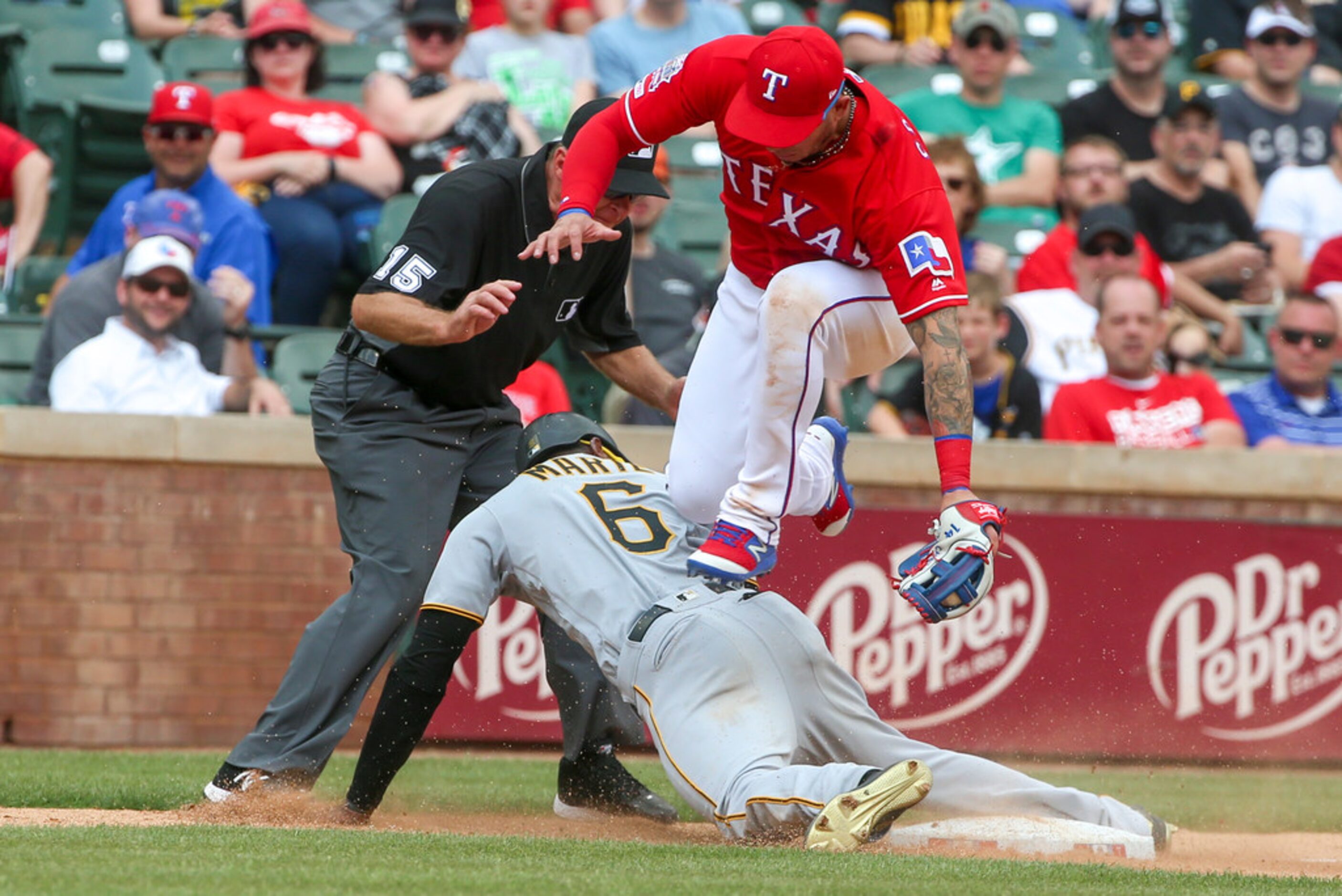 Umpire Ed Hickox (15) looks on as Pittsburgh Pirates center fielder Starling Marte (6)...