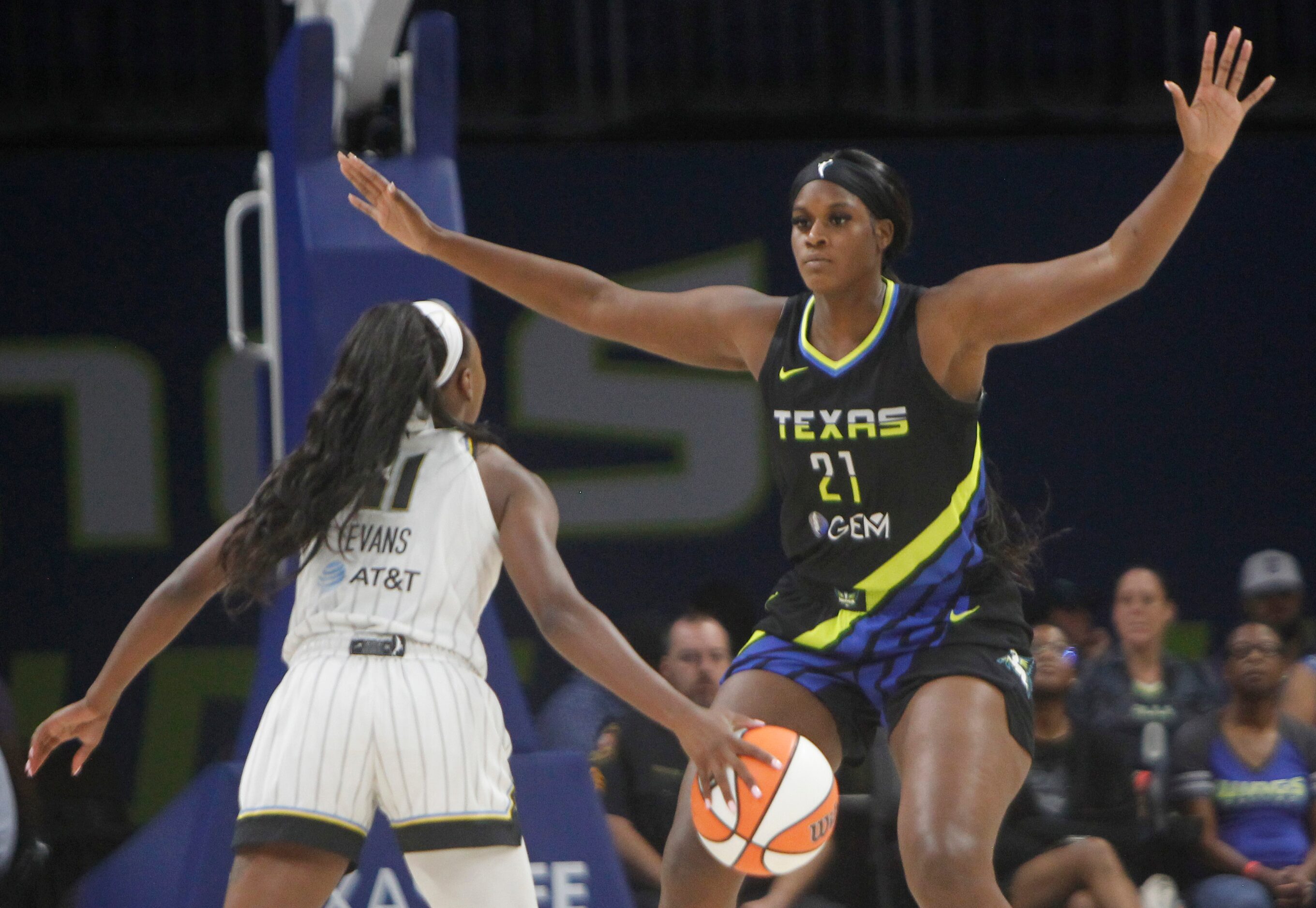 Dallas Wings center Kalani Brown (21) looms large defensively as Chicago Sky guard Dana...