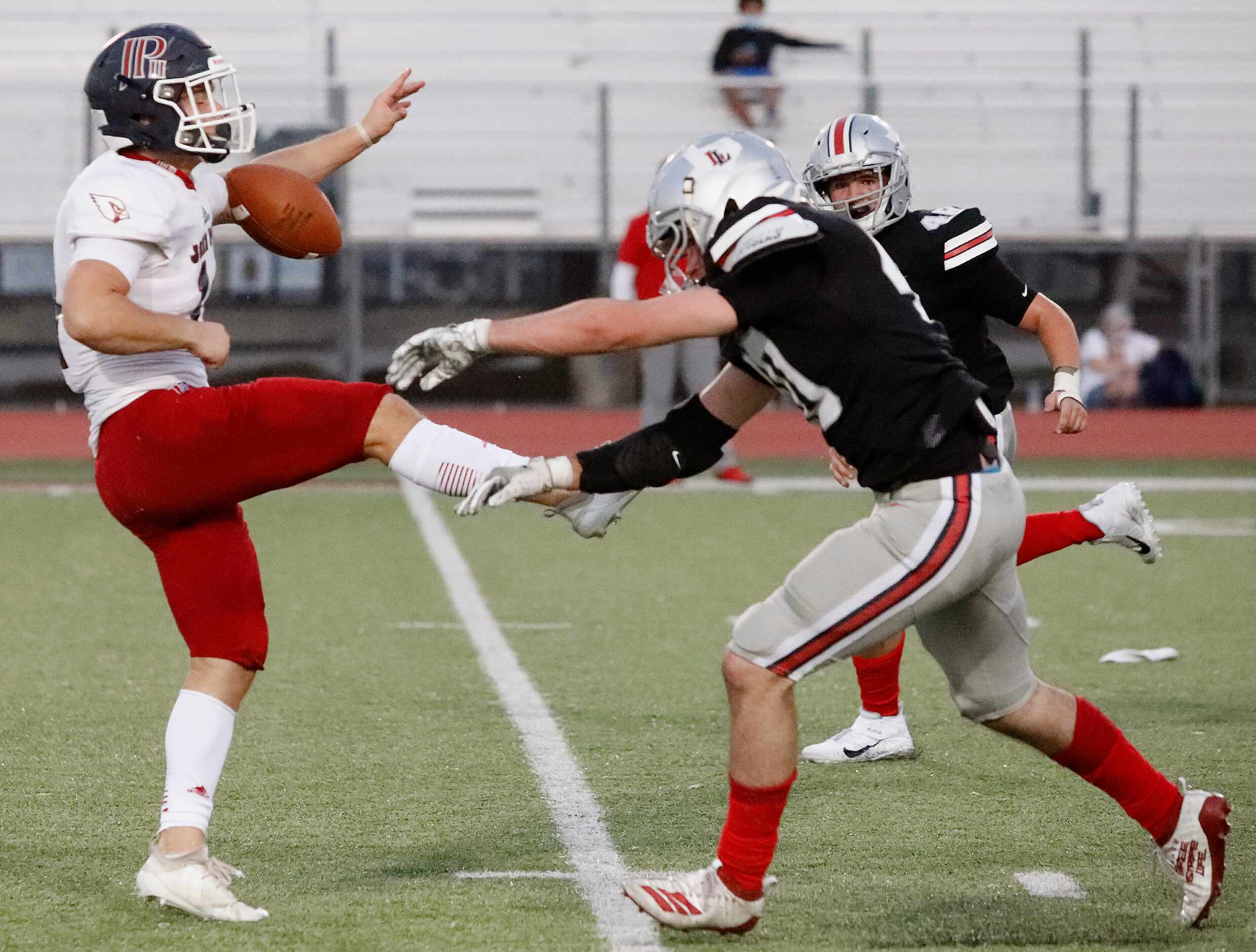 John Paul II High School punter James Knight (14) has his punt blocked by Lovejoy High...