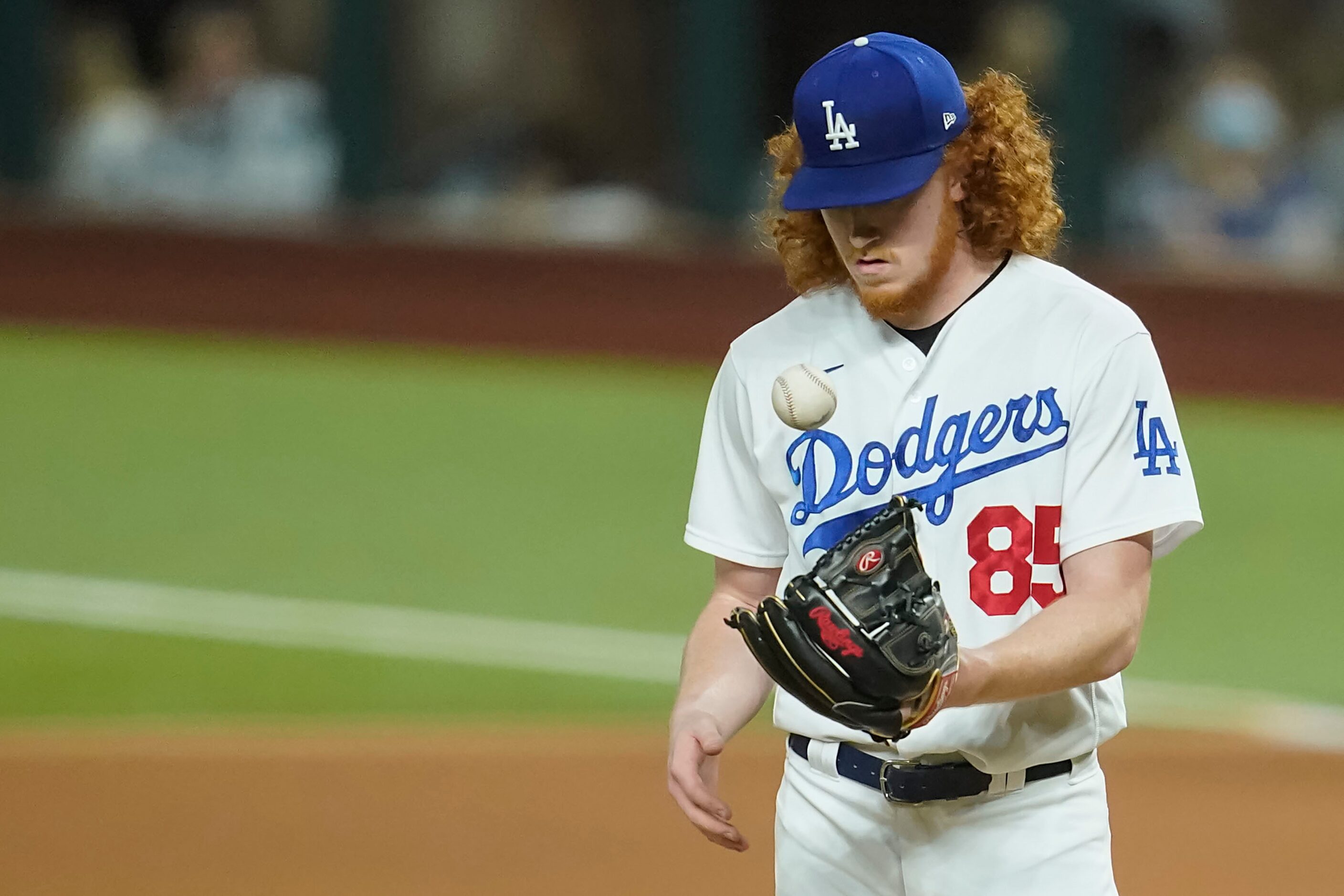 Los Angeles Dodgers starting pitcher Dustin May gets a new ball after giving up a run during...