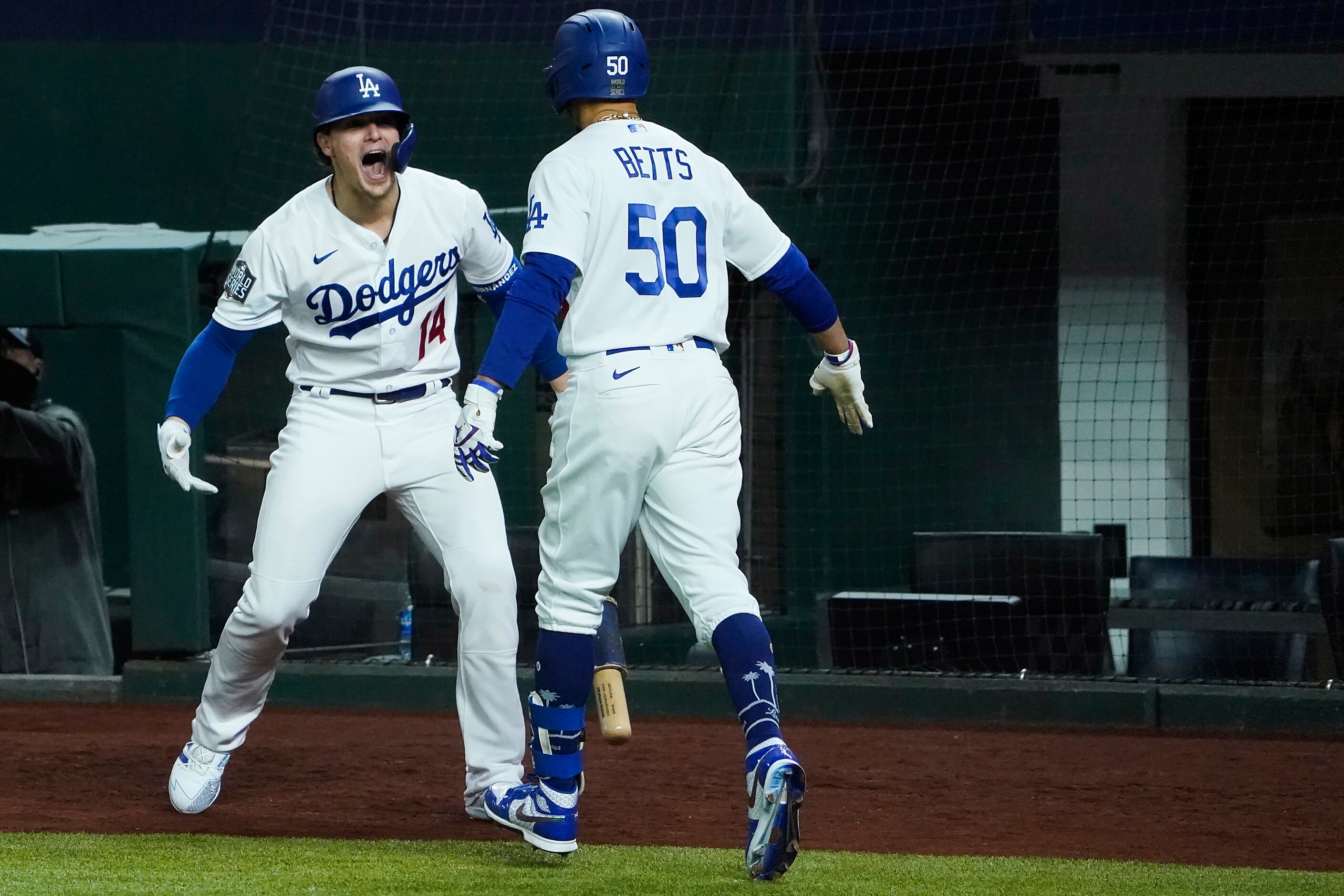Los Angeles Dodgers right fielder Mookie Betts celebrates with second baseman Enrique...
