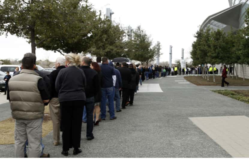 Hundreds of people wait in line to attend the memorial service for former Navy SEAL Chris...