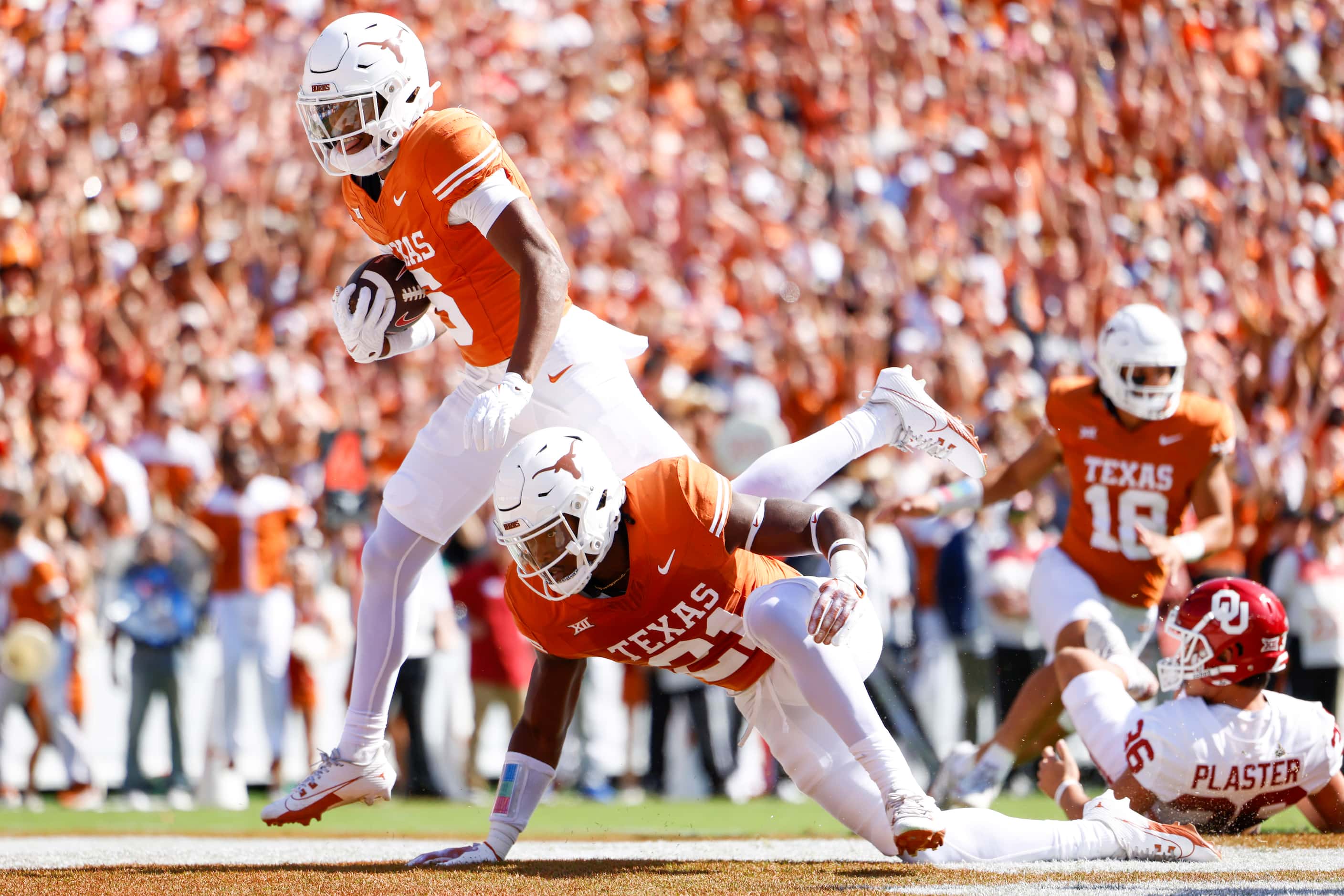 Texas defensive back Ryan Watts (left) scores a touchdown on a rebound against Oklahoma...
