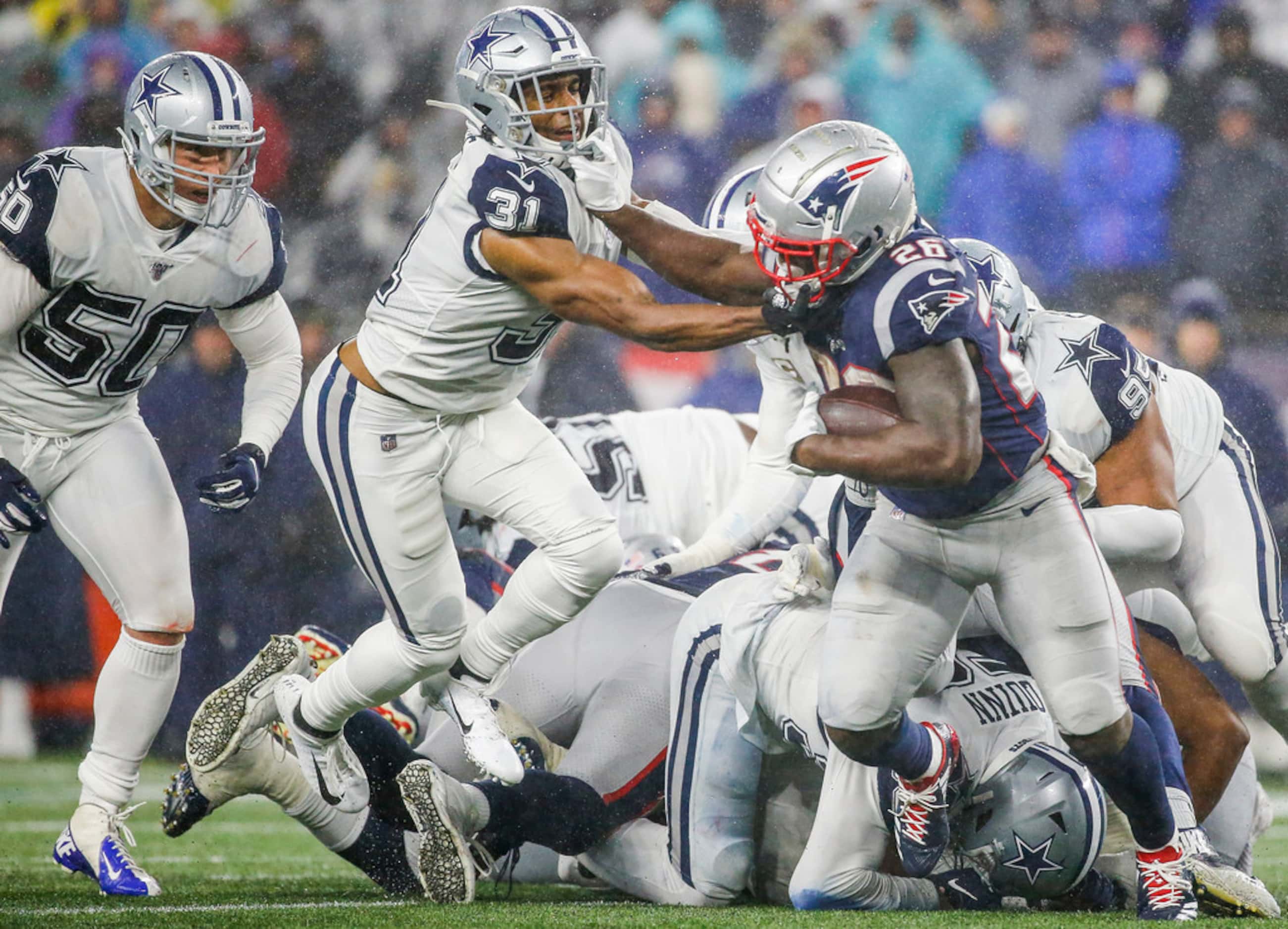 New England Patriots running back Sony Michel (26) attempts to power past Dallas Cowboys...