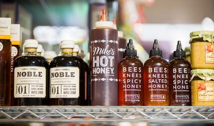 Artisanal honey fills the pop-up's shelves, which are designed to look like baker's racks.