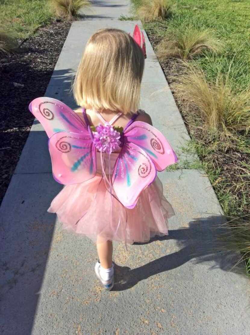 
Clementine heads to the mailbox with fairy wings attached. 
