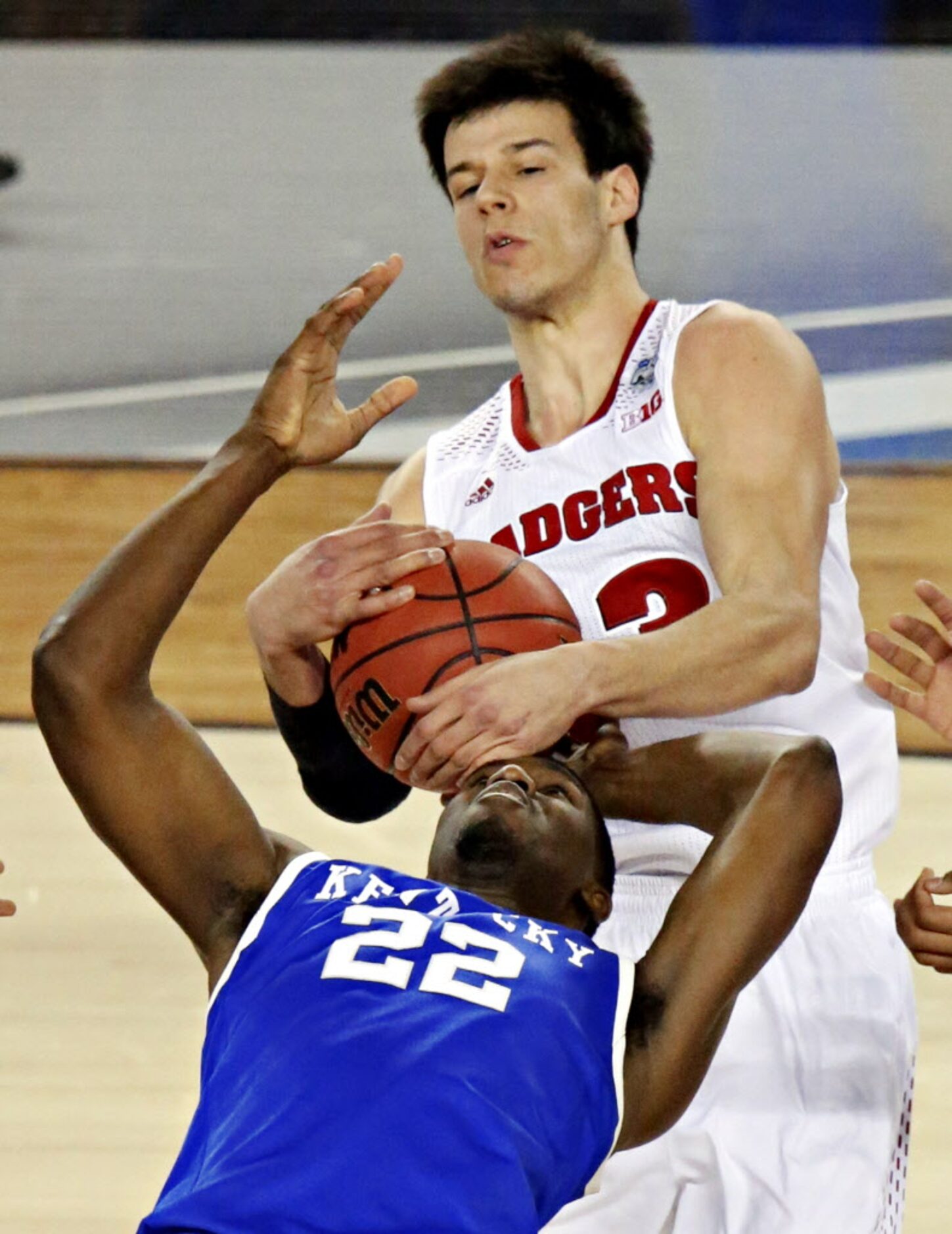 Wisconsin Badgers forward Duje Dukan (13) strips the ball from Kentucky Wildcats forward...