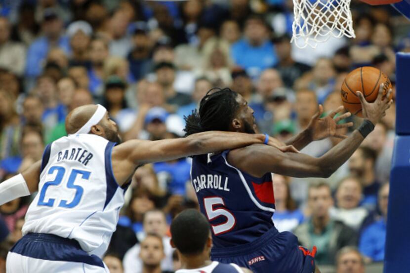 Dallas Mavericks center Samuel Dalembert (1) collides into Charlotte Bobcats center Al...