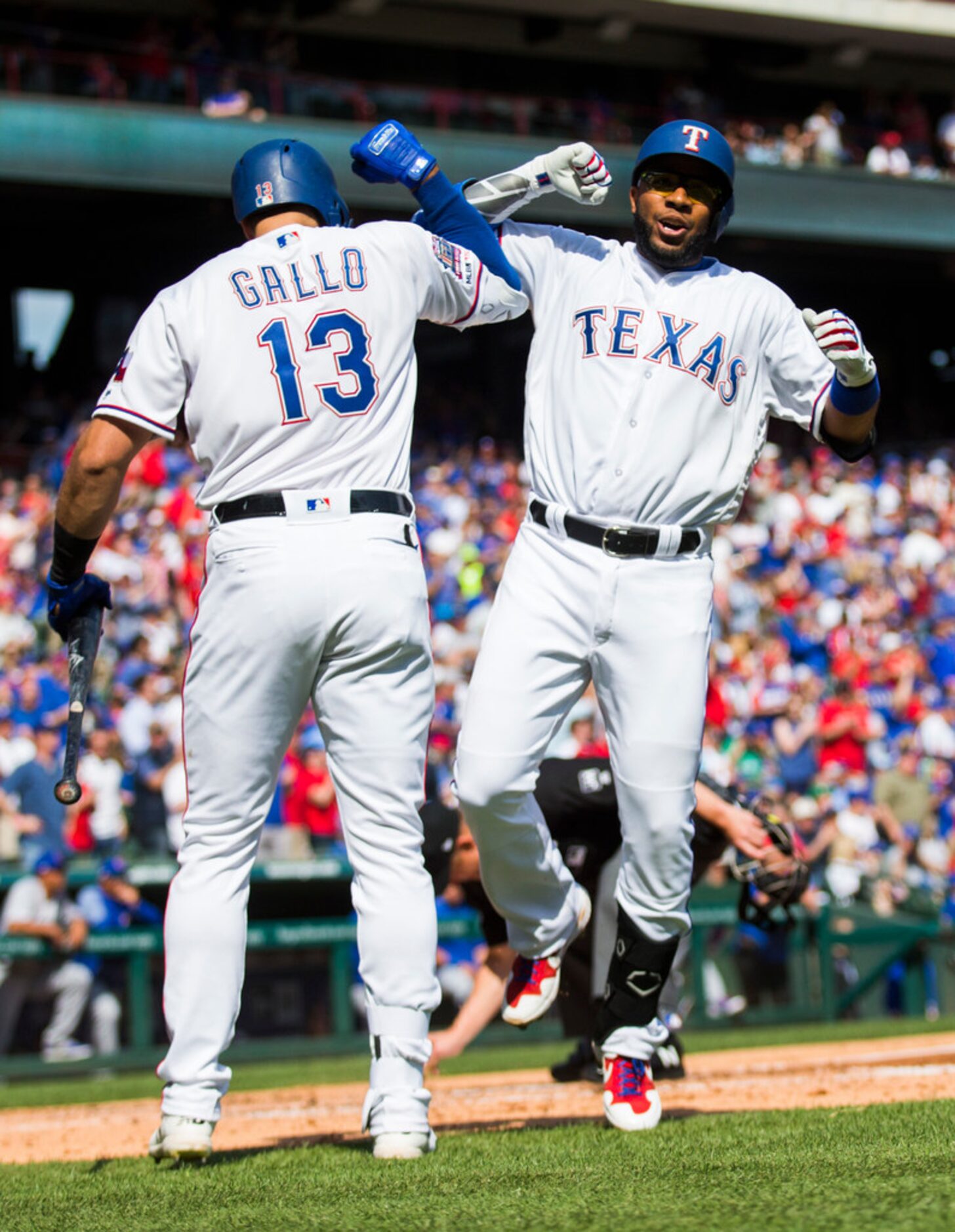 Texas Rangers shortstop Elvis Andrus (1) celebrates with left fielder Joey Gallo (13) after...