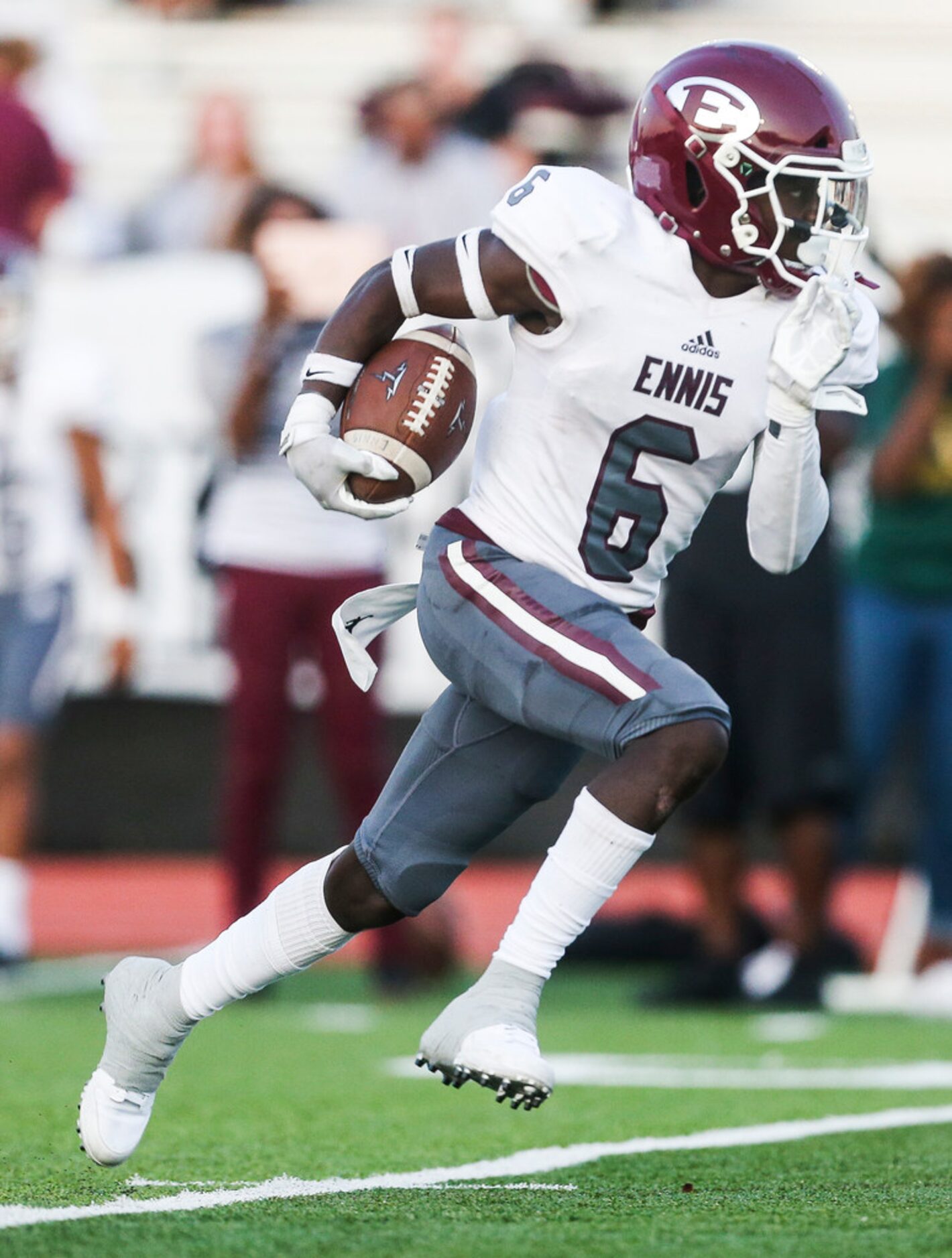 Ennis wide receiver Karon Smith (6) makes a touchdown run during a high school football game...