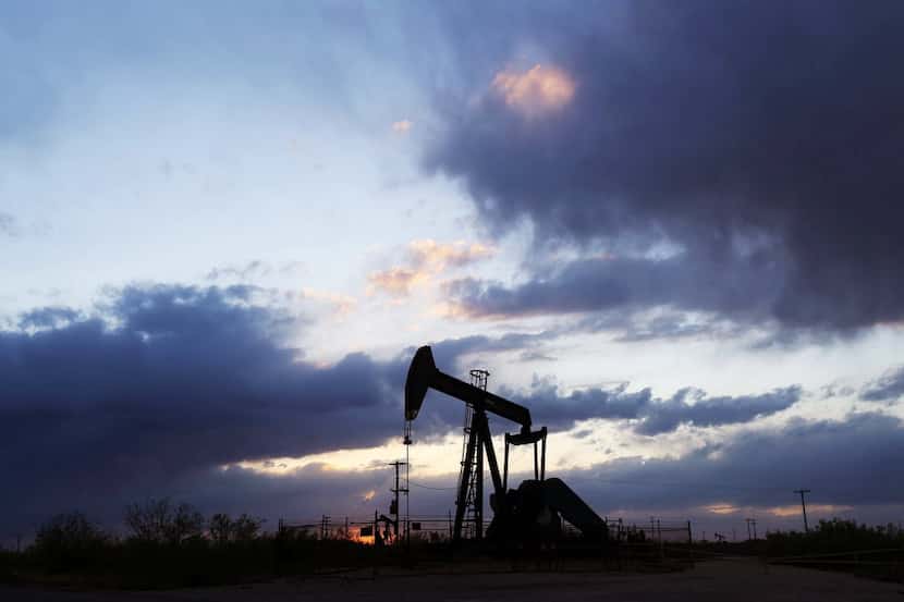 A FILE photo shows a pump jack located off of West County Road before a sunset in May, 2014...