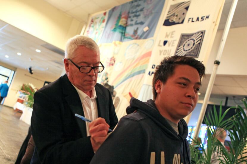 Human rights activist Cleve Jones, creator of the AIDS Memorial Quilt, signs a program for...