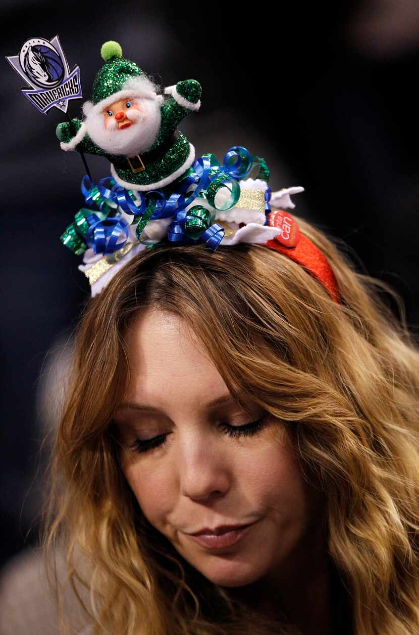 Dallas Mavericks fans Stacey Erhardt of Arlington sports a Christmas head band before seeing...