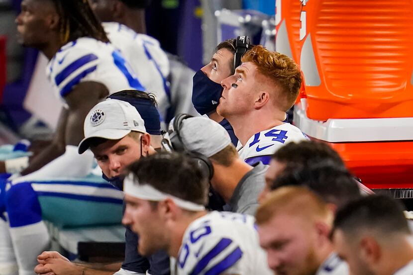 Dallas Cowboys quarterback Andy Dalton watches from the bench with offensive coordinator...