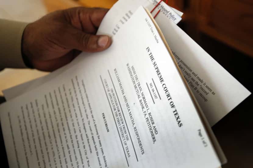 Kenneth Robinson shows some of the state documents that support his legal occupation of a...