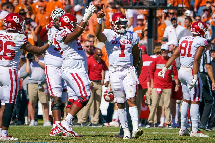 Oklahoma quarterback Jalen Hurts (1) celebrates as time expires on a victory over Texas in...