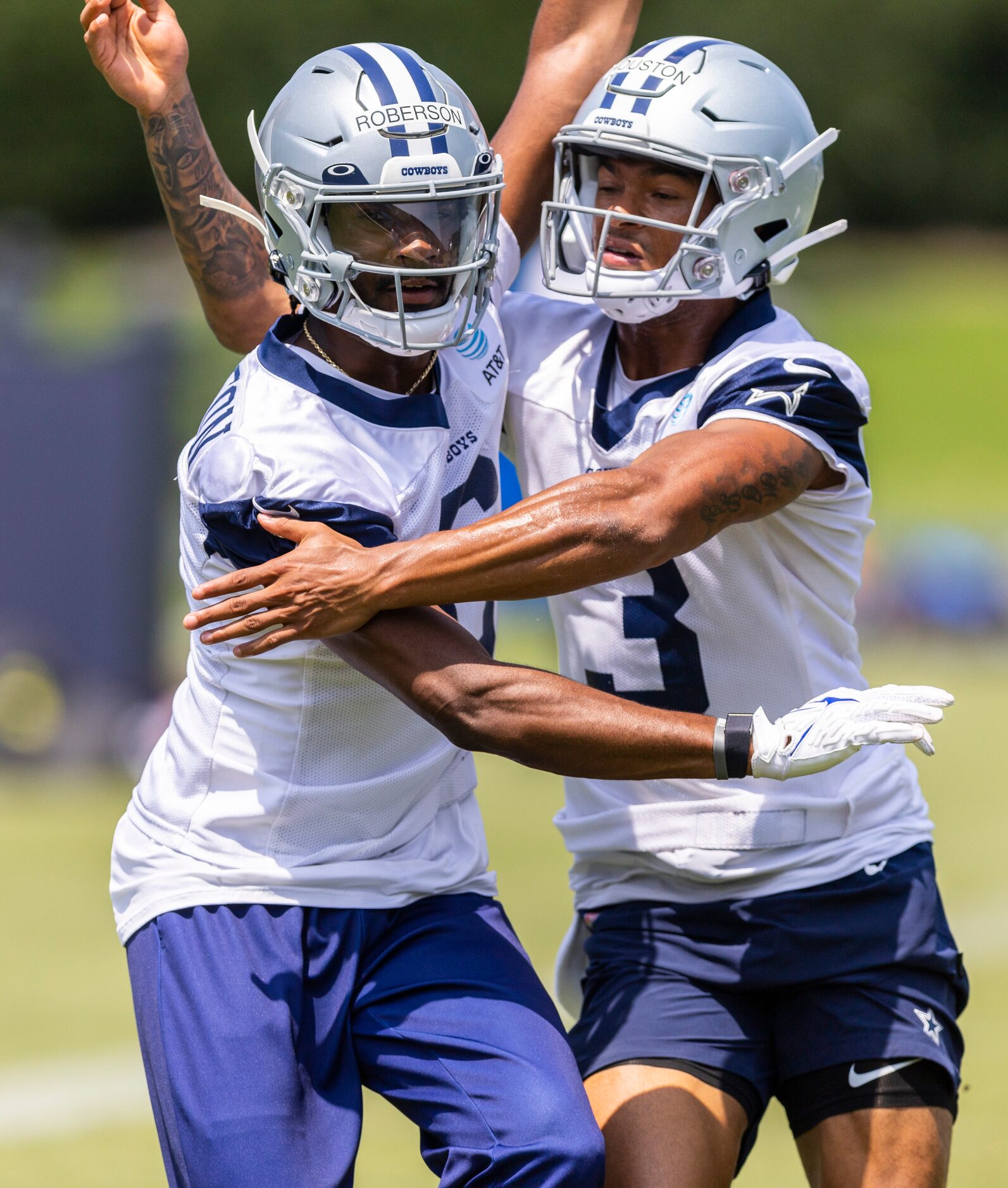 Dallas Cowboys wide receivers Jaquarii Roberson, left, and Dennis Houston, right, run a...