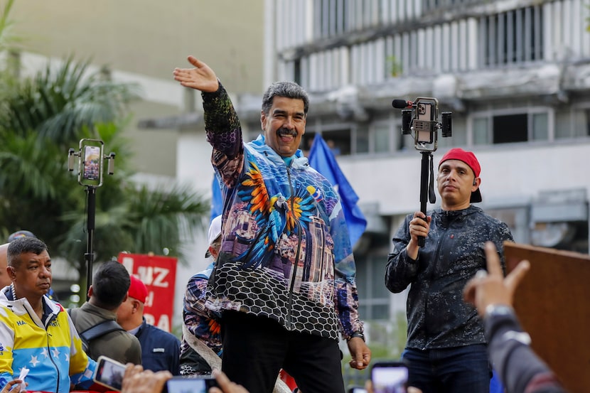 President Nicolas Maduro waves to the crowd during a rally launching the official...