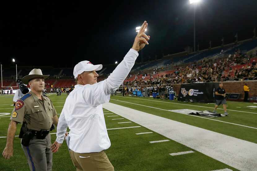Southern Methodist Mustangs head coach Chad Morris waves to the crowd after a 31-24 loss to...