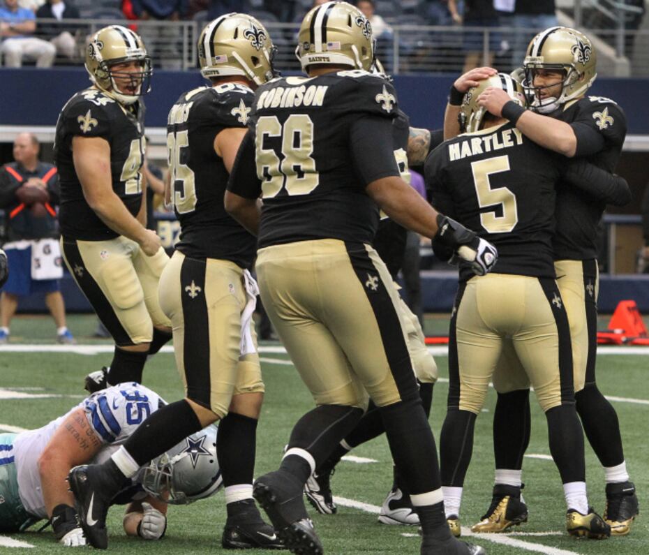 Dallas Cowboys free safety Gerald Sensabaugh (43) tries to bring down New  Orleans Saints wide receiver Marques Colston (12) during the first half of  an NFL football game Sunday, Dec. 23, 2012