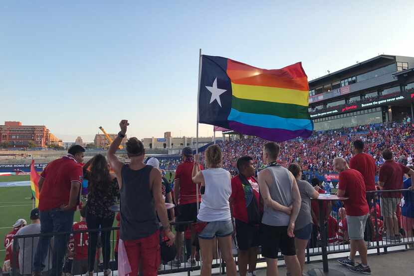 Members of the Dallas Beer Guardians hold a Texas Pride flag during the group's LGBTQ Pride...