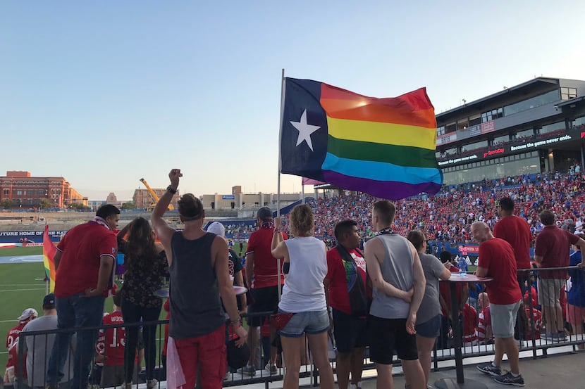 Members of the Dallas Beer Guardians hold a Texas Pride flag during the group's LGBTQ Pride...