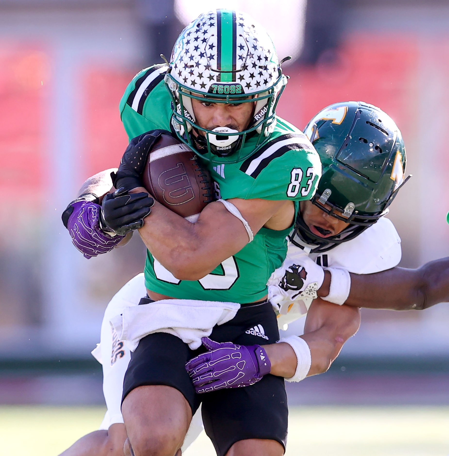 Southlake Carroll running back Christian Glenn (83) runs hard against Longview defensive...