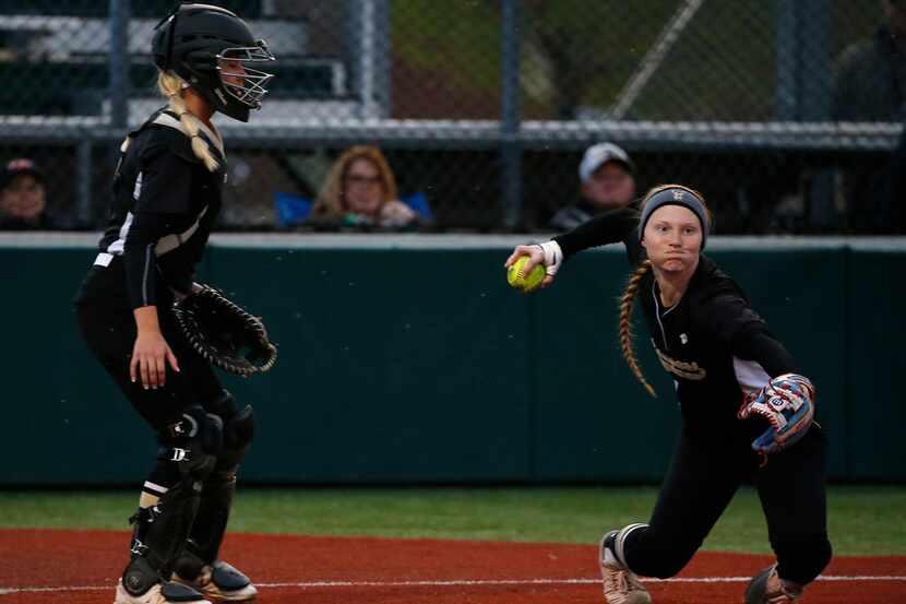 The Colony's Madison Hirsch, right, throws the ball to first next to catcher Jacee Hamlin...