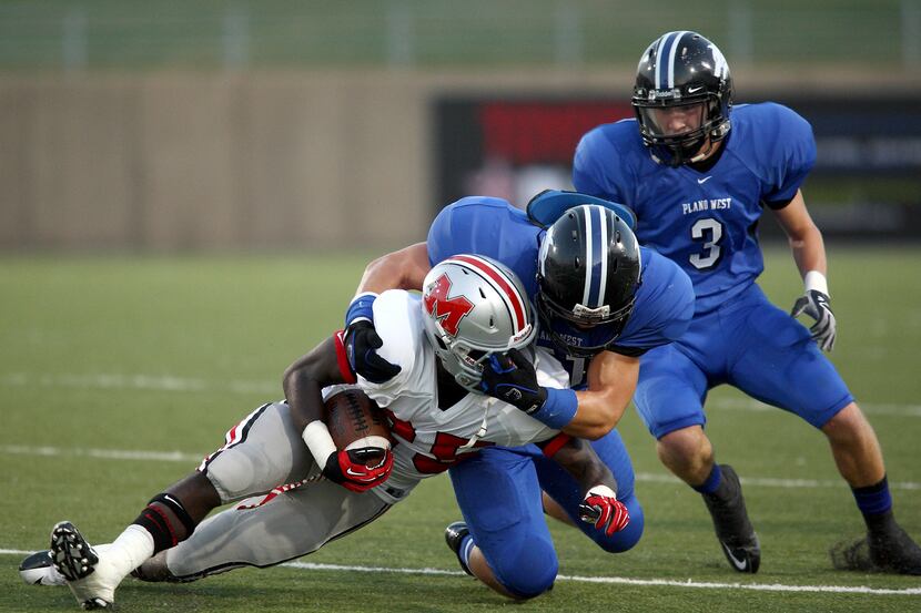 Plano West linebacker Jake Wodka takes down a Flower Mound Marcus opponent during the teams’...