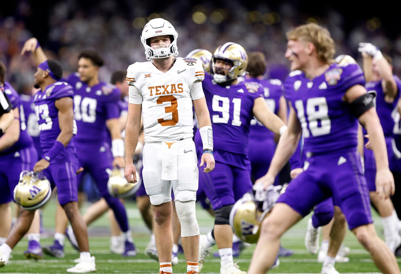 Washington Huskies football players celebrate their Sugar Bowl over Texas Longhorns...