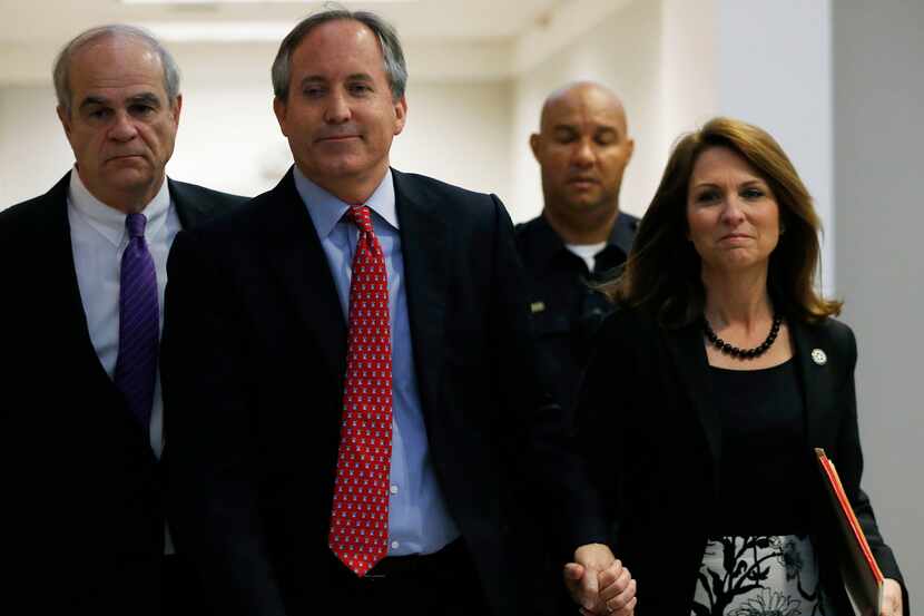 Texas Attorney General Ken Paxton and his wife, Angela Paxton, enter the Merrill Hartman...