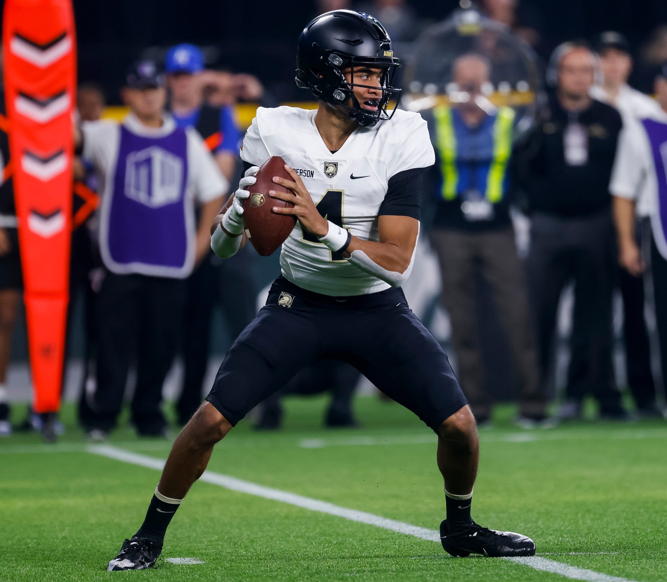 Army Black Knights quarterback Christian Anderson (4) looks after the snap during the first...