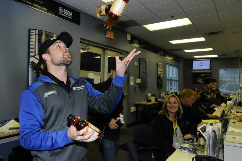 Ricky Stenhouse Jr. juggles drink bottles in the media center after the NASCAR Sprint Cup...
