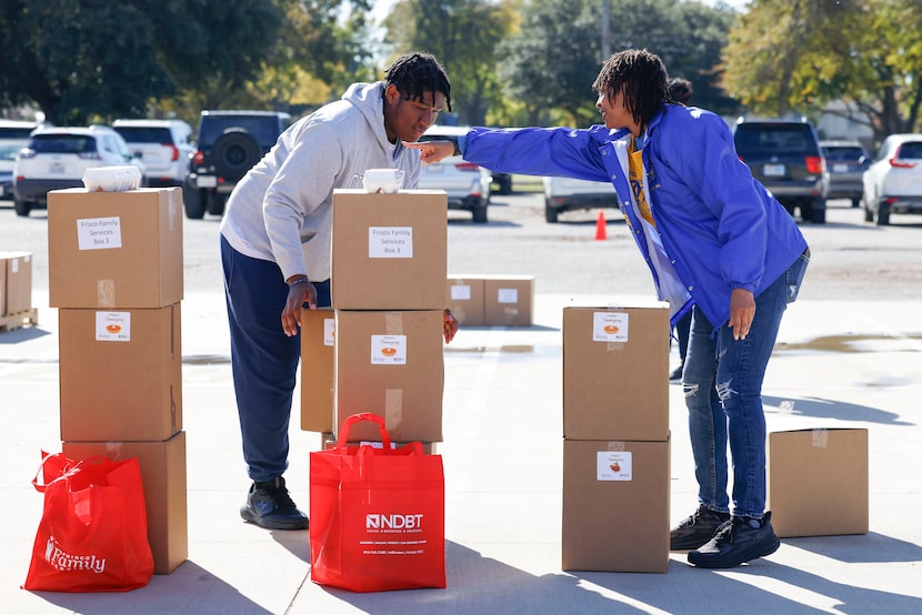 Helper Cameraon Riojas  (left) and Lisa Bailey with Sigma Gamma Rho sorority inc. arranges...