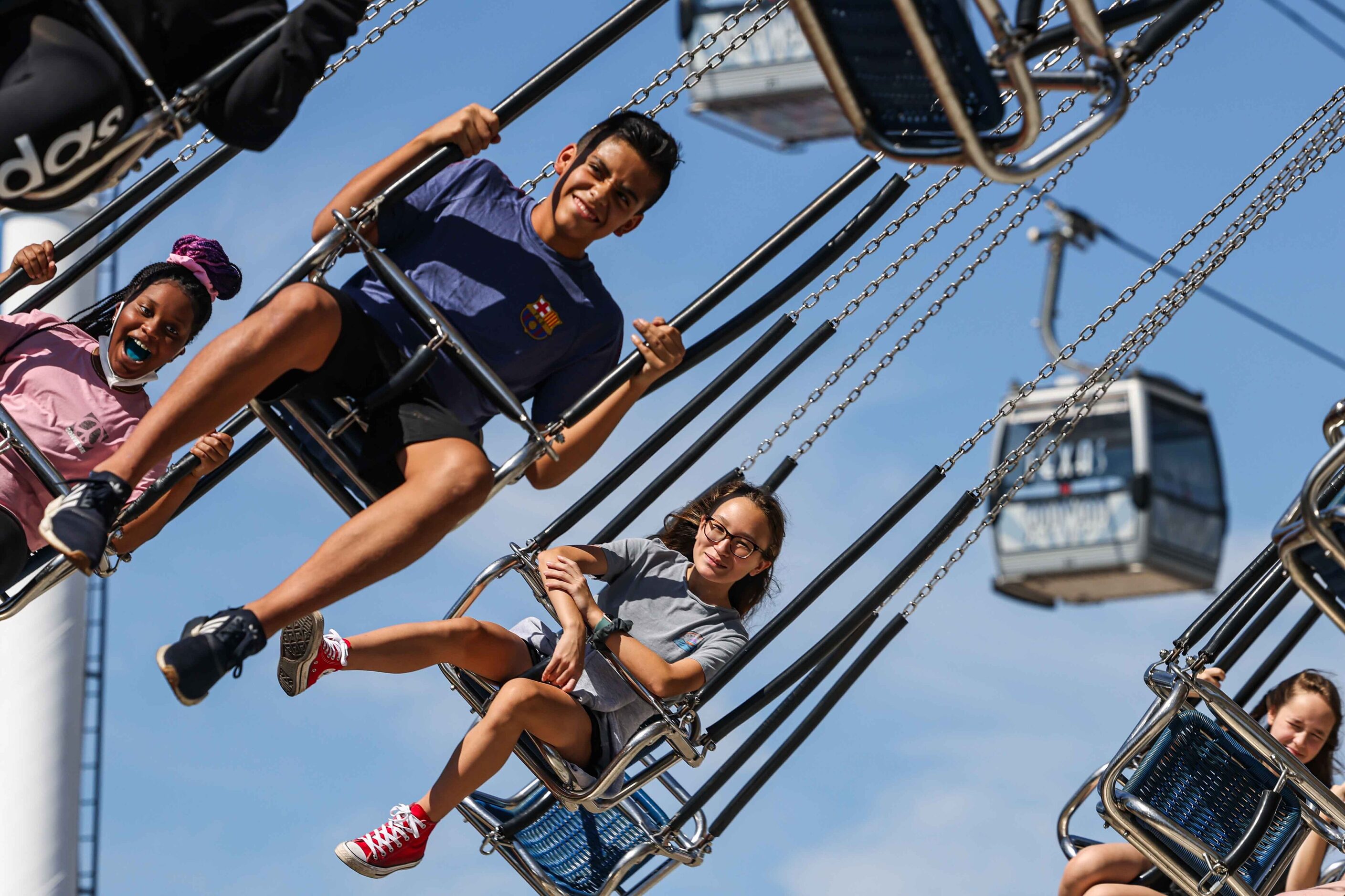 People  aboard a carnival ride at the State Fair of Texas during its opening day in Dallas...