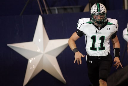 Riley Dodge, cq, runs back to the sidelines after scoring his first of two running...