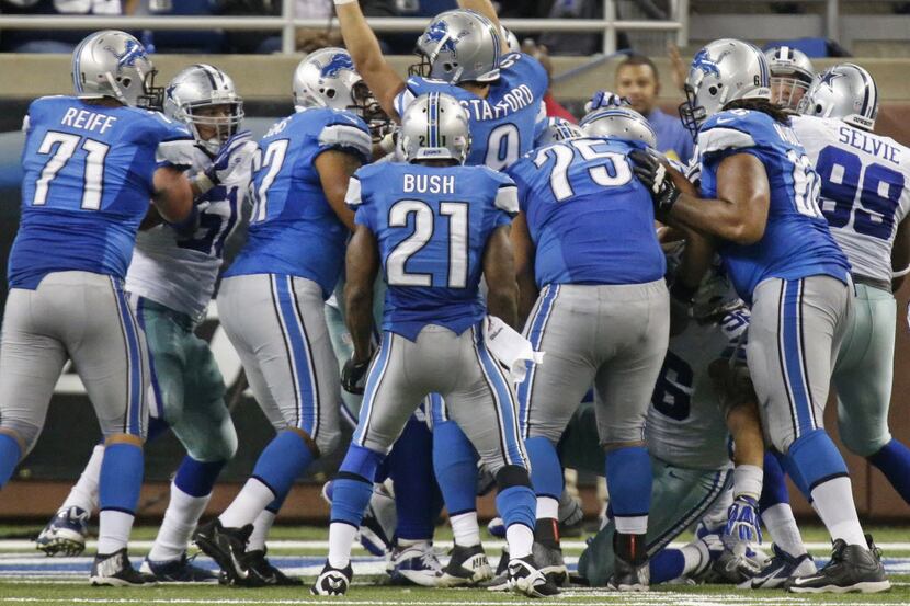 Detroit Lions quarterback Matthew Stafford (9) celebrates after getting in the end zone for...