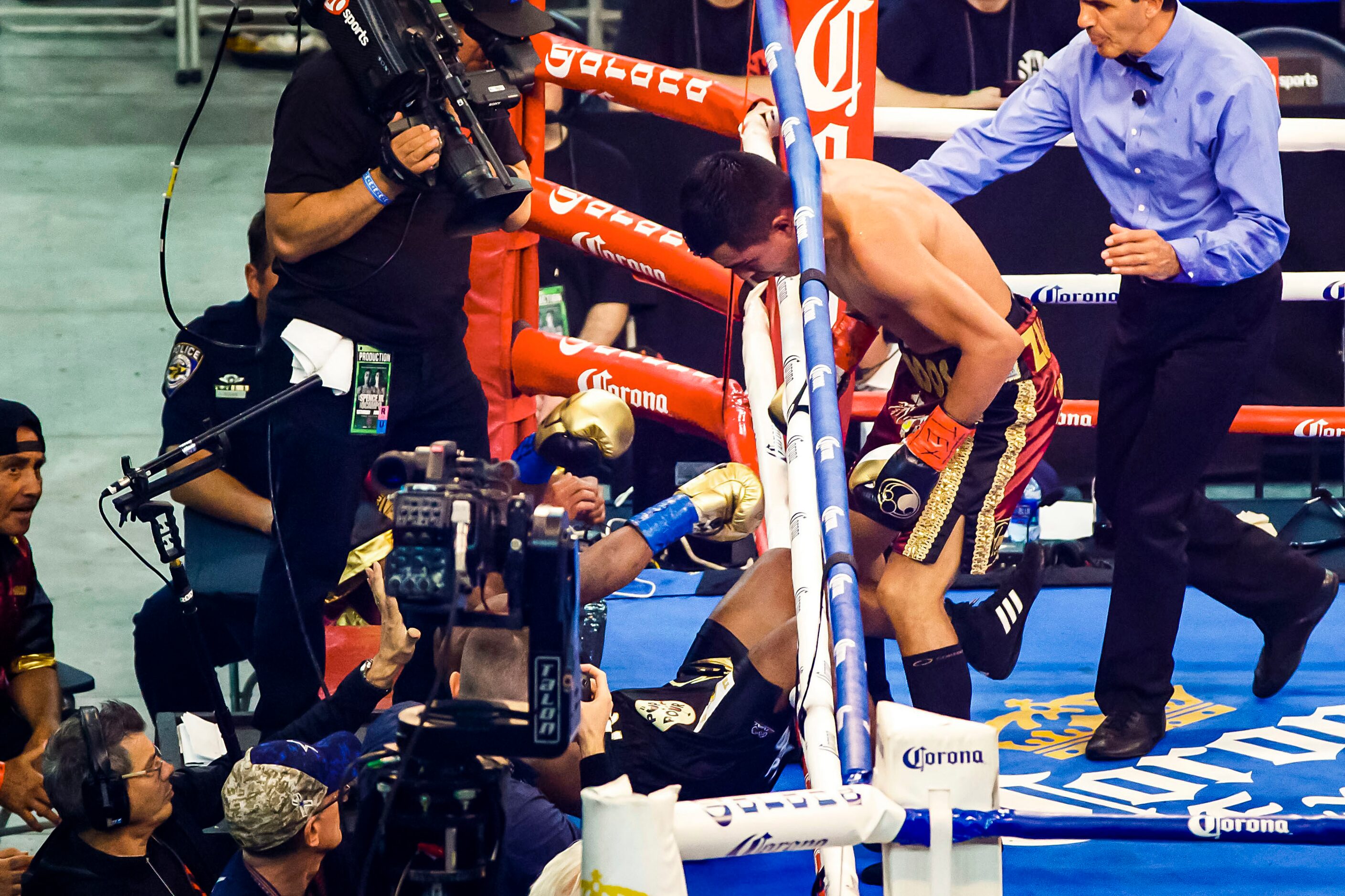 Javier Fortuna (left), of La Romana, Dominican Republic, tumbles out of the ring during an...