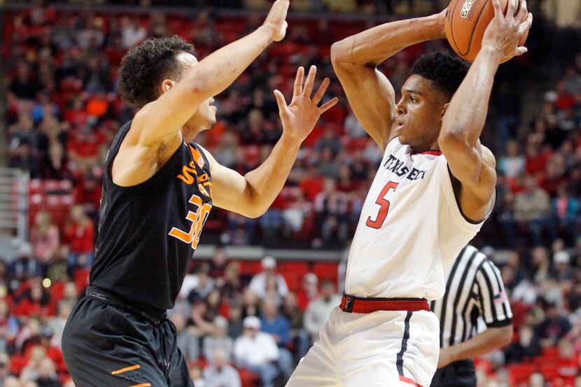 Texas Tech forward Justin Gray is guarded by Oklahoma State guard Jeffrey Carroll during the...
