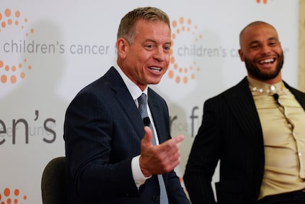 Former Dallas Cowboys quarterback Troy Aikman (left) shares a laugh with Dallas Cowboys...