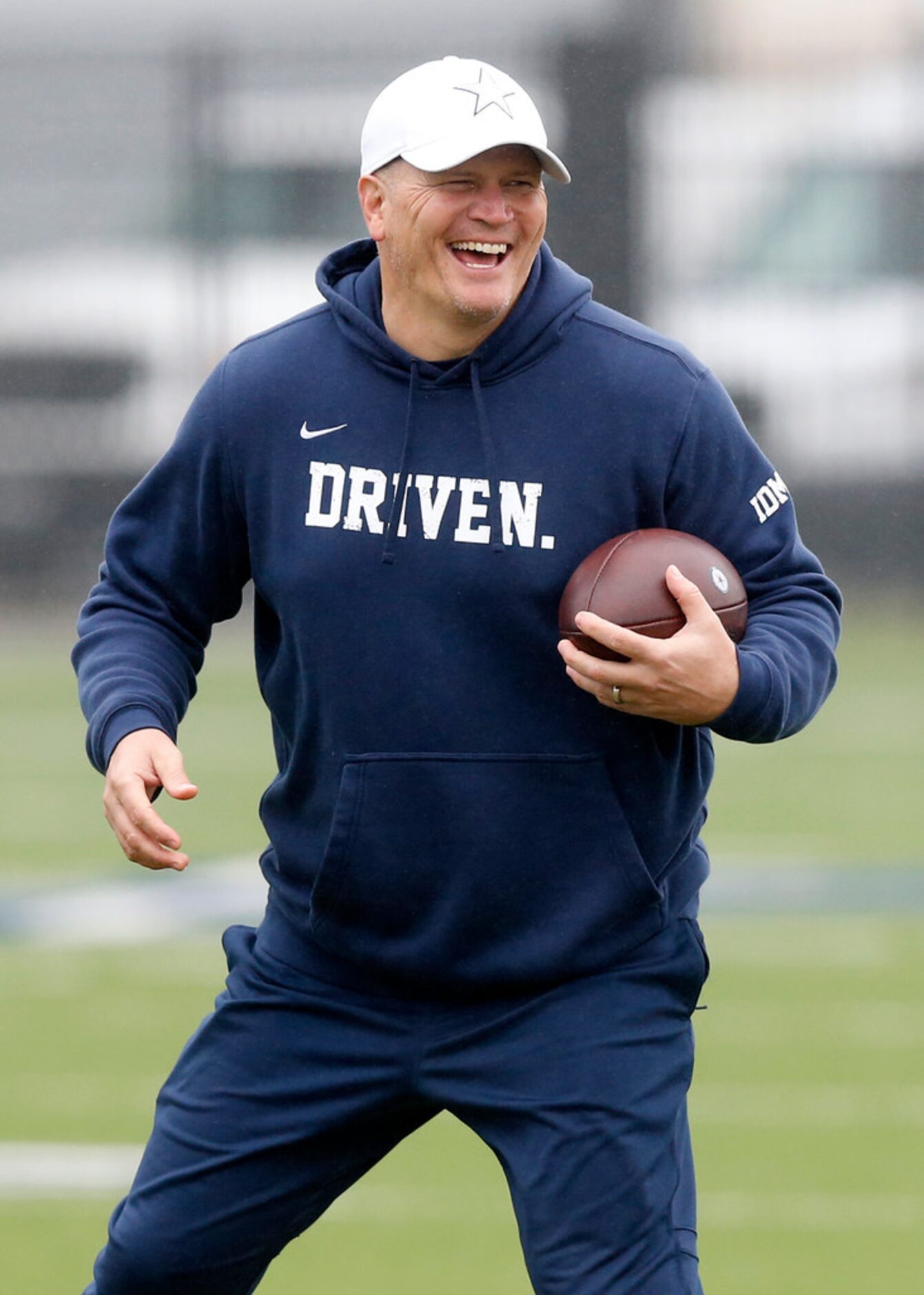 Dallas Cowboys quarterbacks coach Jon Kitna laughs at Dak Prescott during practice at The...