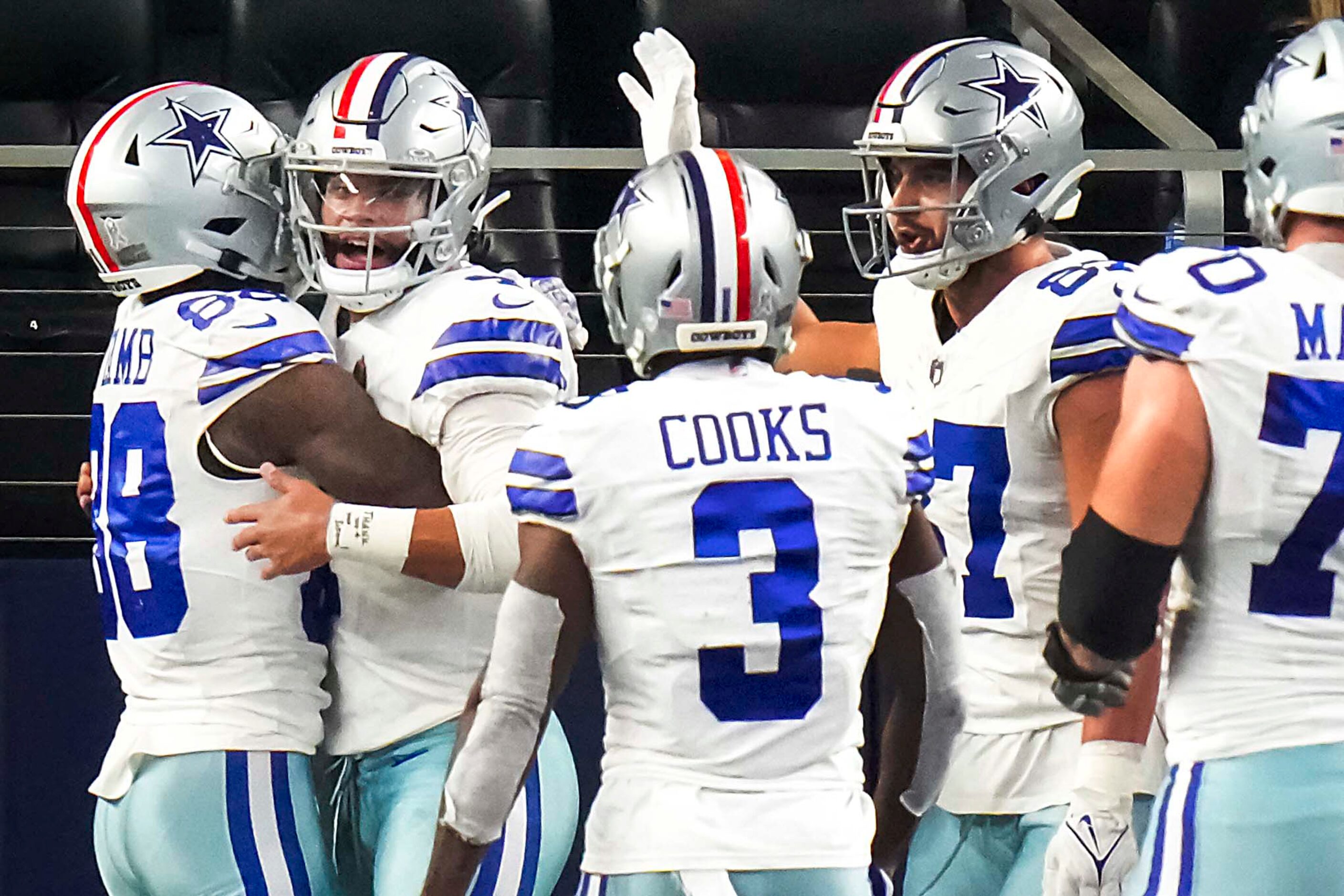 Dallas Cowboys quarterback Dak Prescott (4) celebrates with wide receiver CeeDee Lamb (88),...