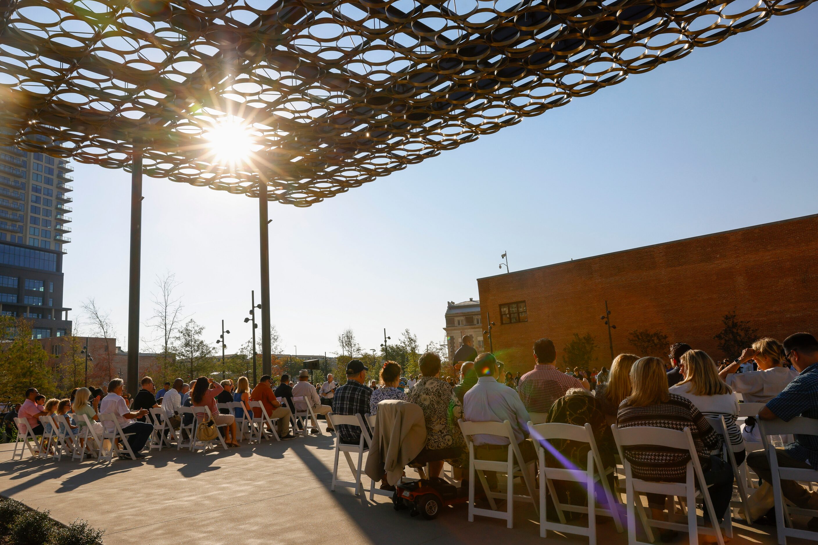 Attendees listen to speakers from the pavilion during the opening day of Harwood Park, on...